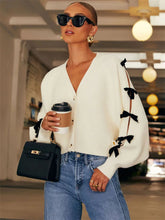 Manteau en maille côtelée ajourée à nœud