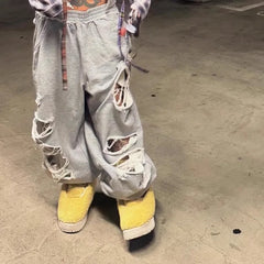 Pantalon de sport à jambes larges et trous irréguliers