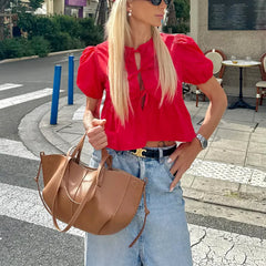 Blouse élégante à manches bouffantes et péplum