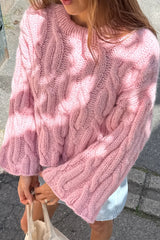 Pull court rose à torsades ample