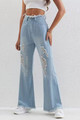 Jean slim évasé bleu délavé à ourlet brut et patchwork déchiré